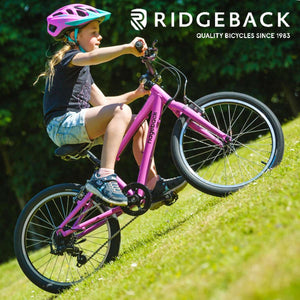  Girl cycling on a Ridgeback Dimension 20 pink bike. 