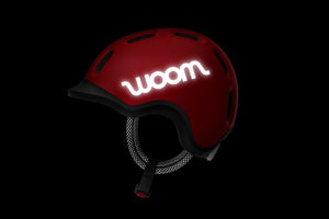 Woom READY red kids' helmet reflective features.