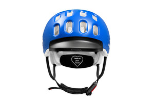 Front view of the Woom sky blue kids helmet showing rubber visor and Fidlock® magnetic closure system.