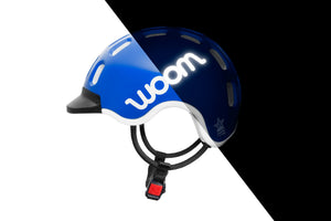 Side view of the Woom sky blue kids helmet showing the reflective logo.