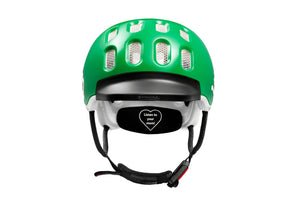 Front view of the Woom green kids helmet showing rubber visor and Fidlock® magnetic closure system.