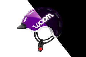 Side view of the Woom purple haze kids helmet showing the reflective logo.