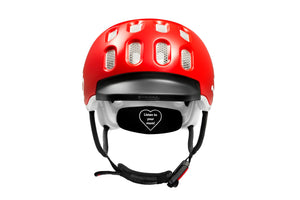 Front view of the Woom red kids helmet showing rubber visor and Fidlock® magnetic closure system.
