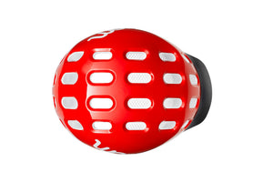 Top view of the Woom red kids helmet showing an array of vents for cooling.
