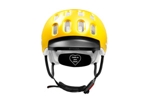 Front view of the Woom sunny yellow kids helmet showing rubber visor and Fidlock® magnetic closure system.