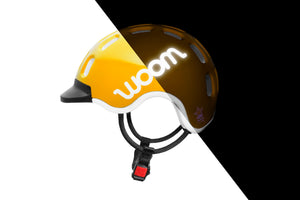Side view of the Woom sunny yellow kids helmet showing the reflective logo.